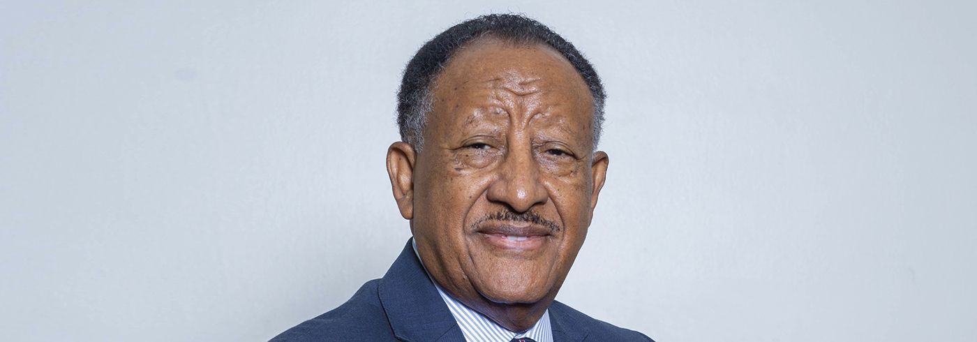 A man in a suit and tie is smiling for the camera.