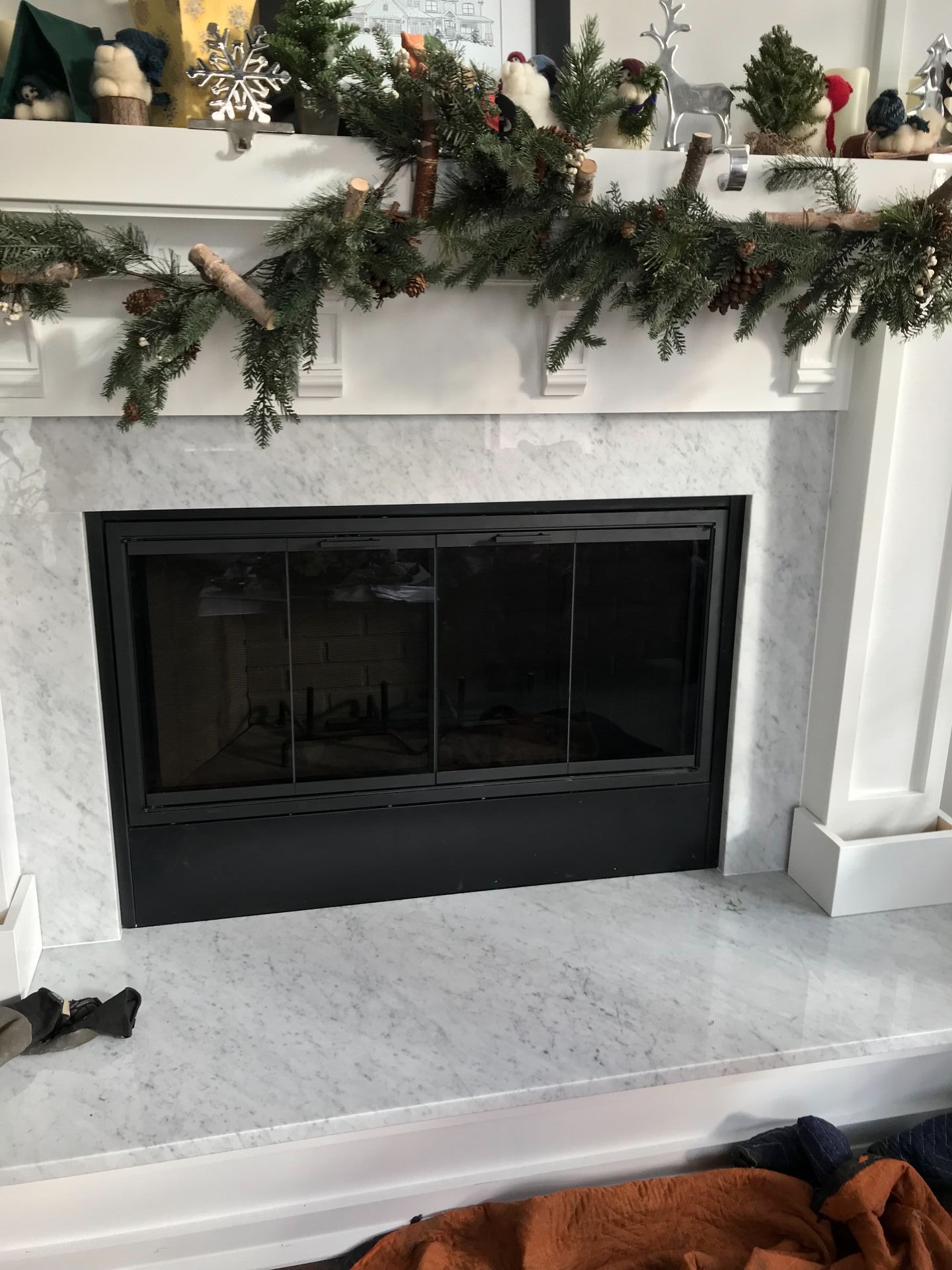 A fireplace with a mantle decorated for christmas
