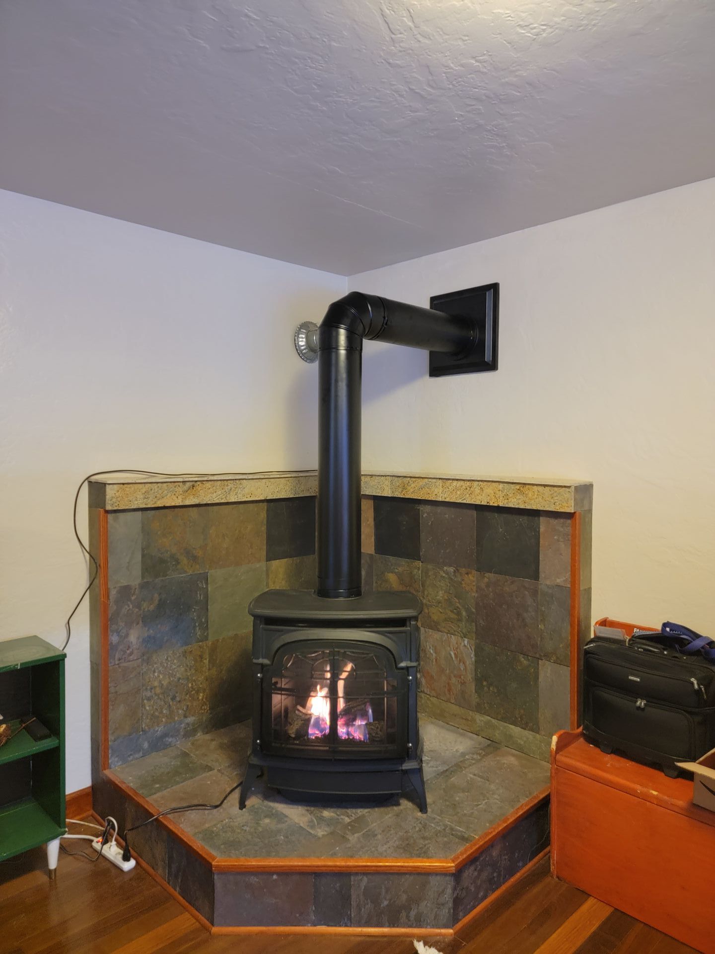 A wood stove is sitting in the corner of a living room