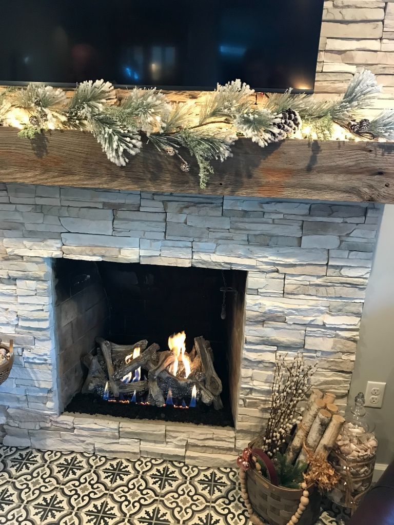 A living room with a fireplace and a flat screen tv.