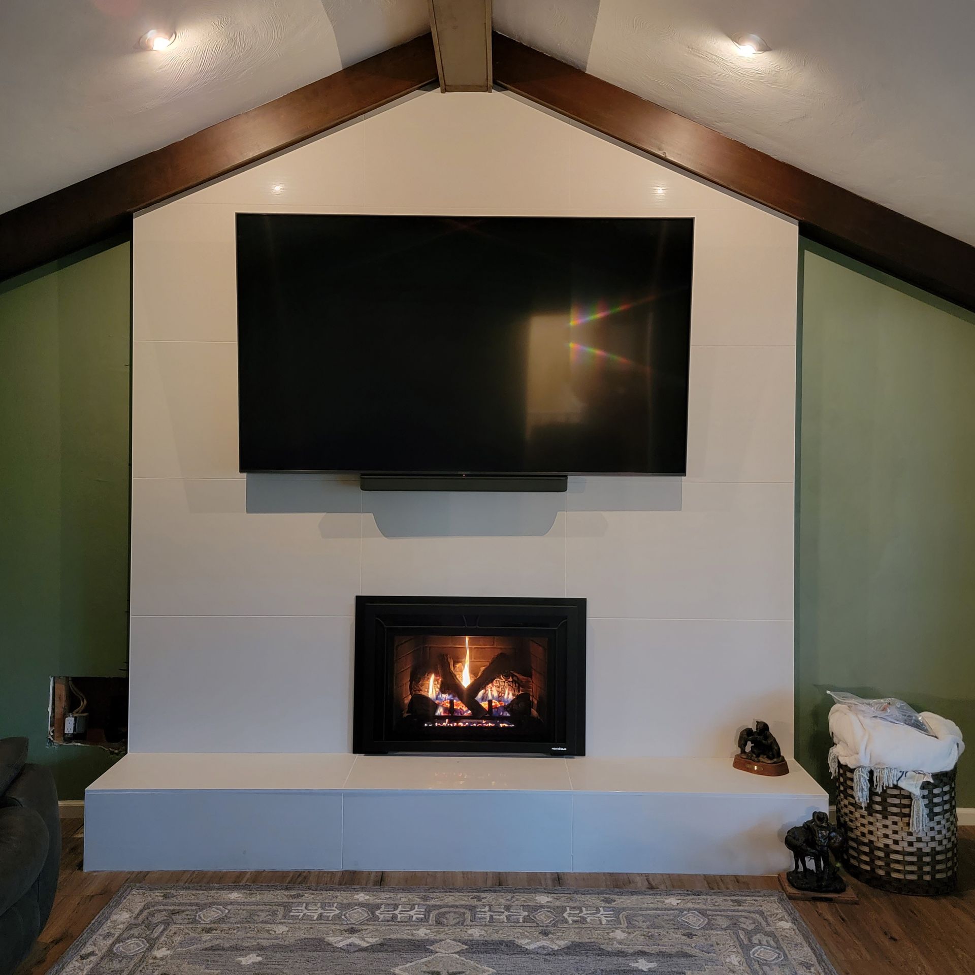 A living room with a fireplace and a flat screen tv