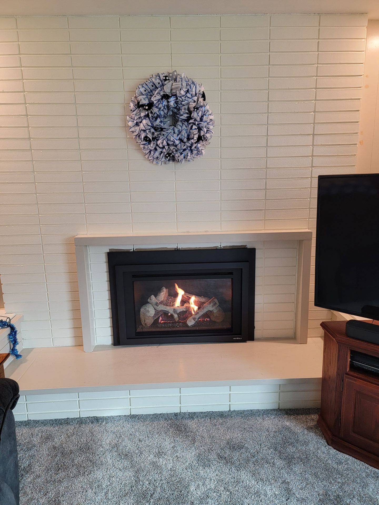 A living room with a fireplace and a television.