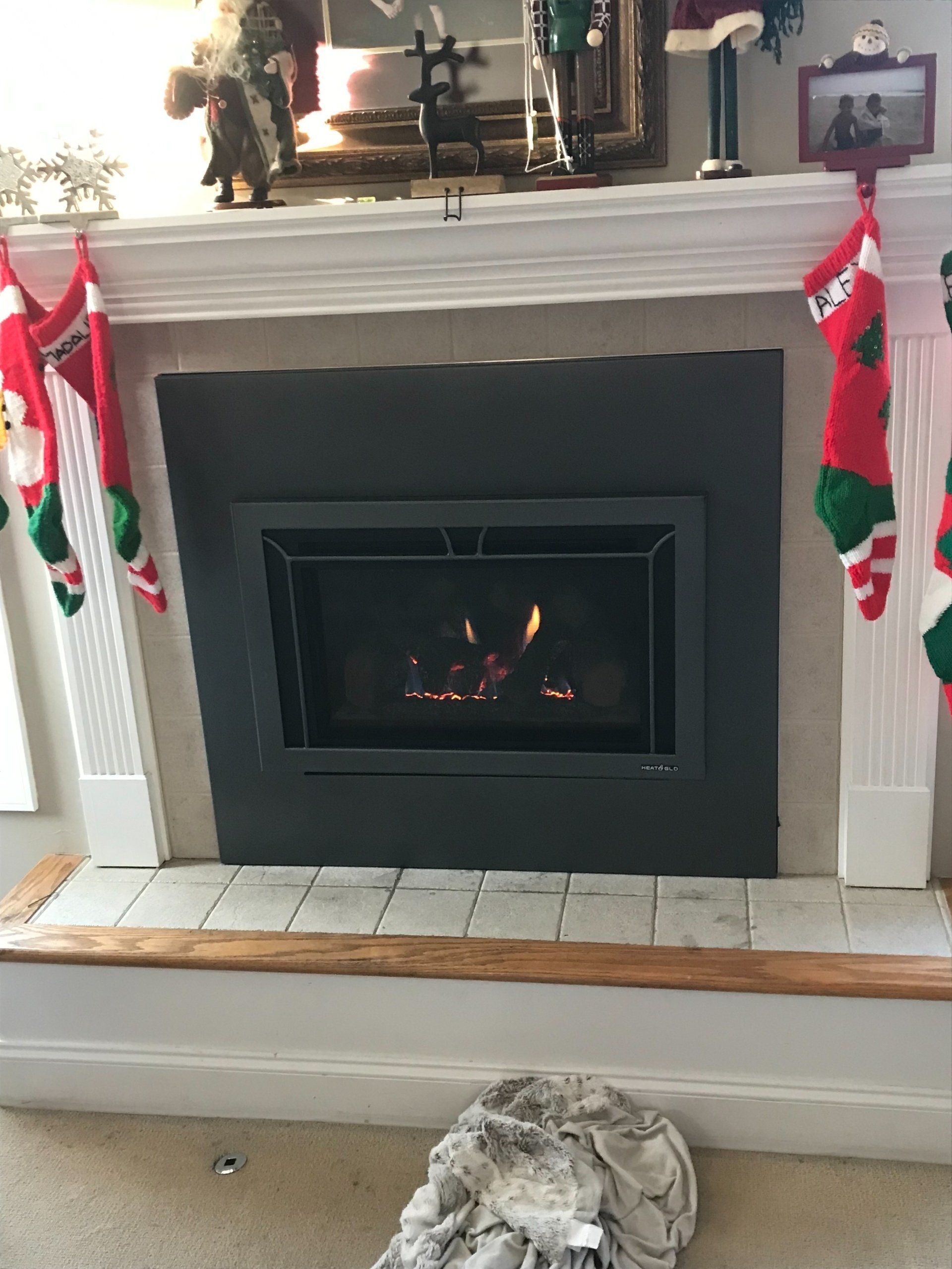 A fireplace with christmas stockings hanging on the mantle.