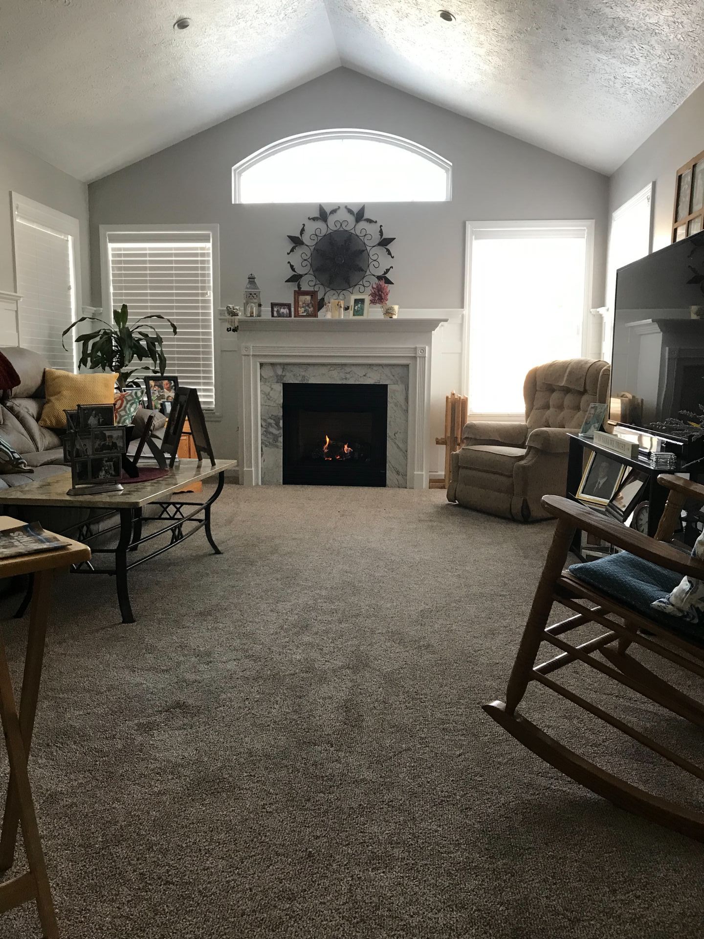 A living room filled with furniture and a fireplace.