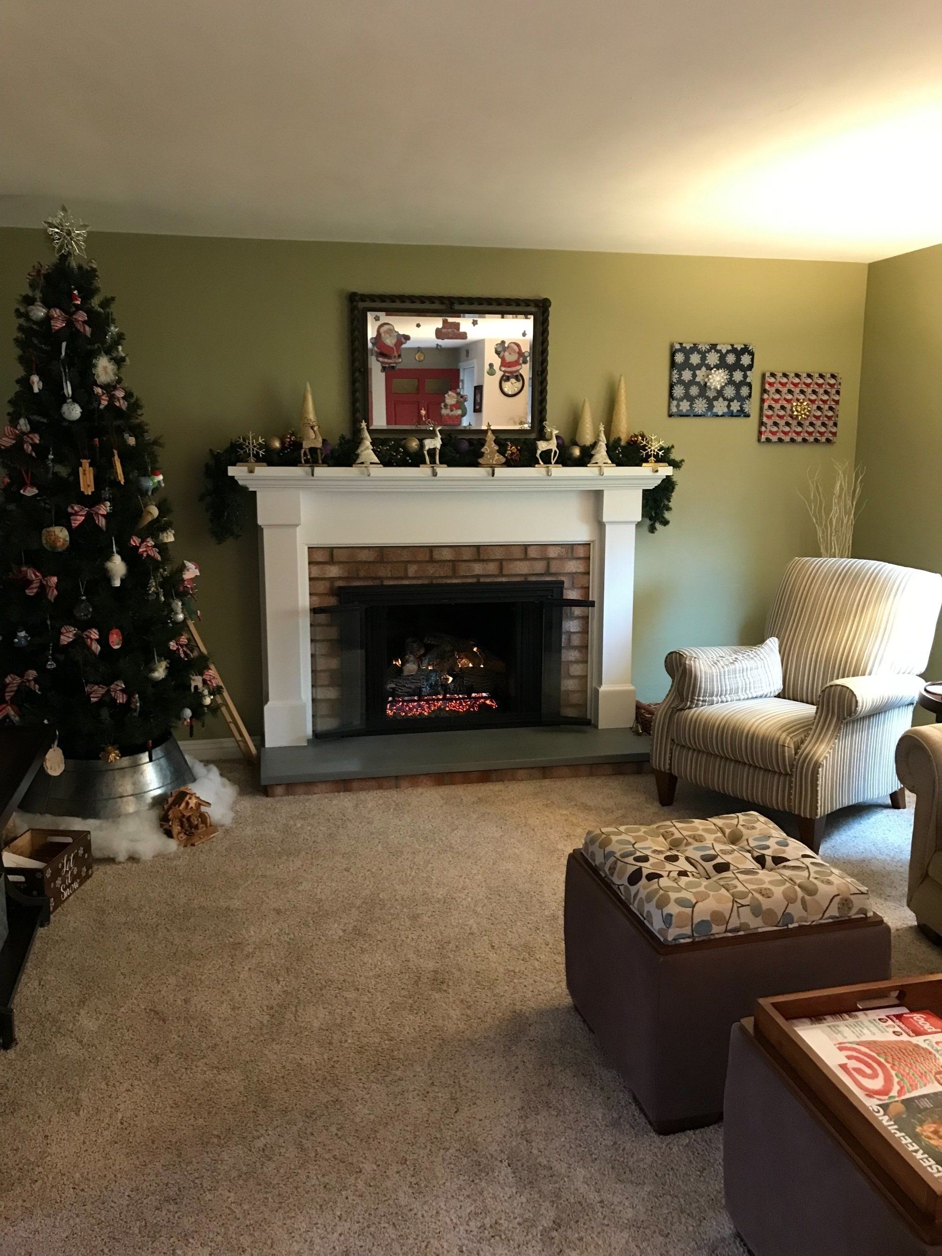 A living room with a fireplace and a christmas tree