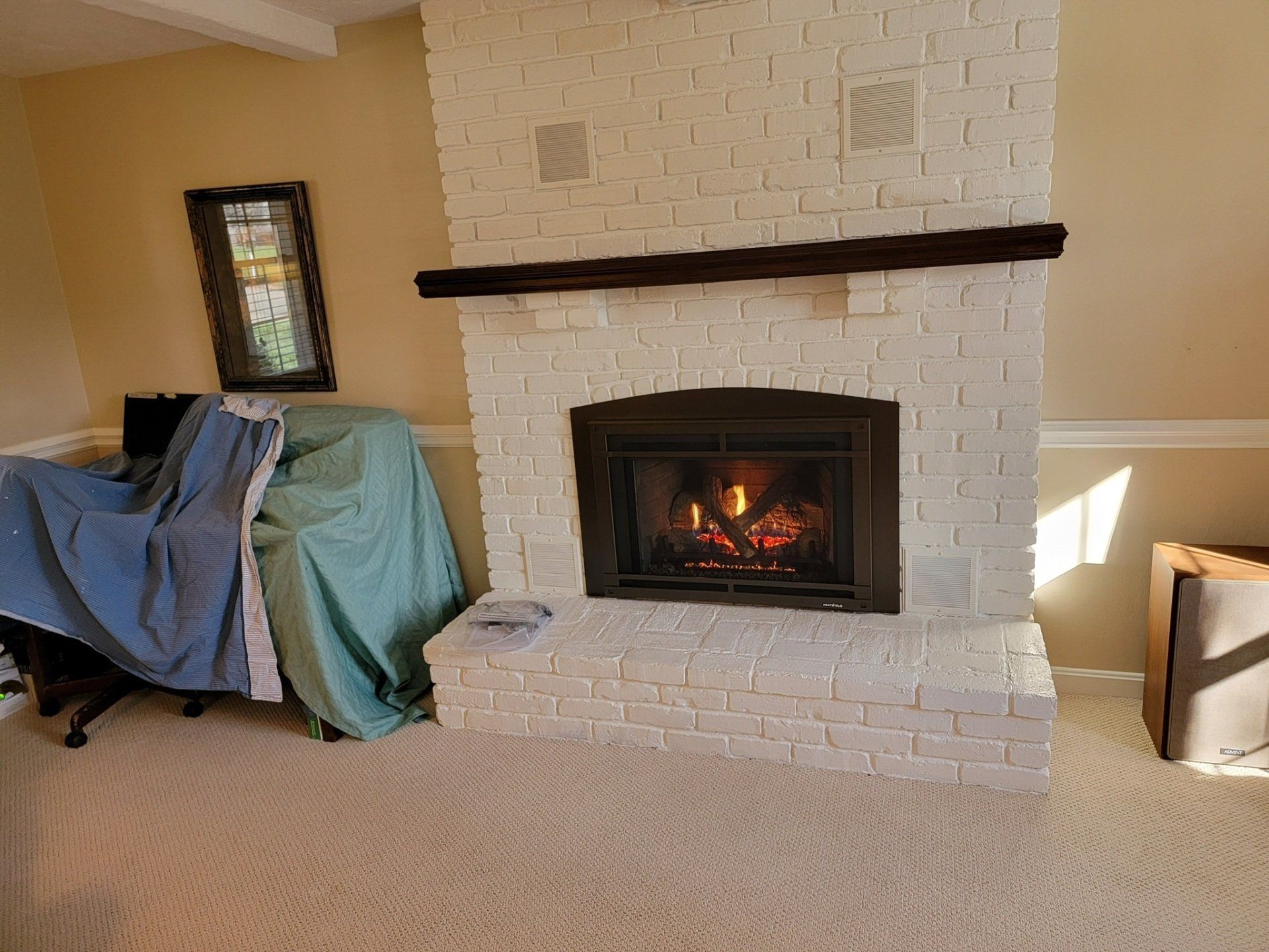 A living room with a fireplace and a chair.