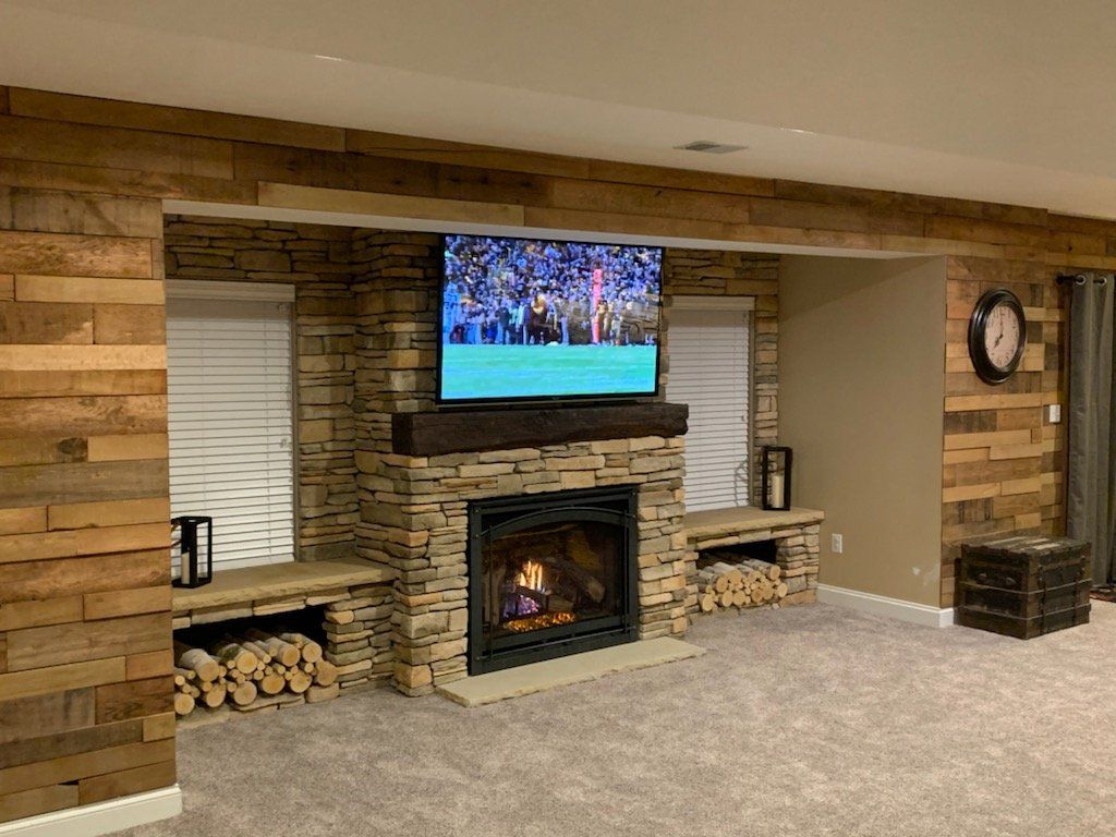A living room with a fireplace and a flat screen tv.