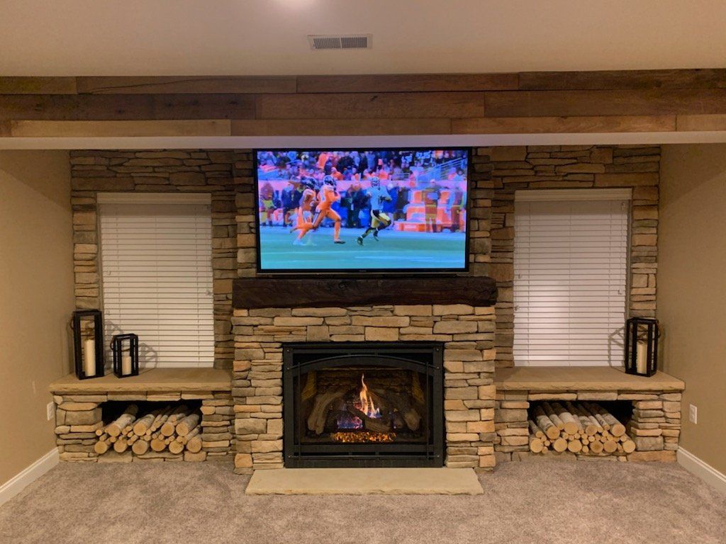A living room with a fireplace and a flat screen tv.