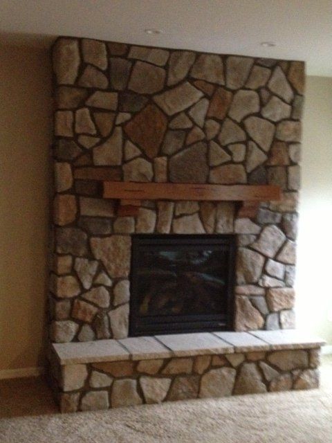A large stone fireplace in a living room