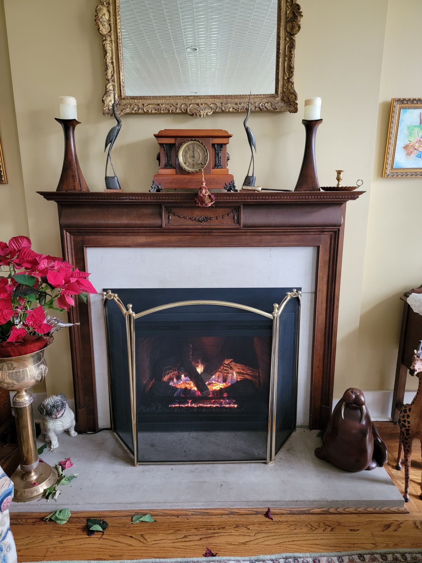 A living room with a fireplace and a clock on the mantle.