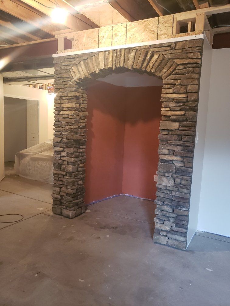 There is a stone archway in the middle of the room.