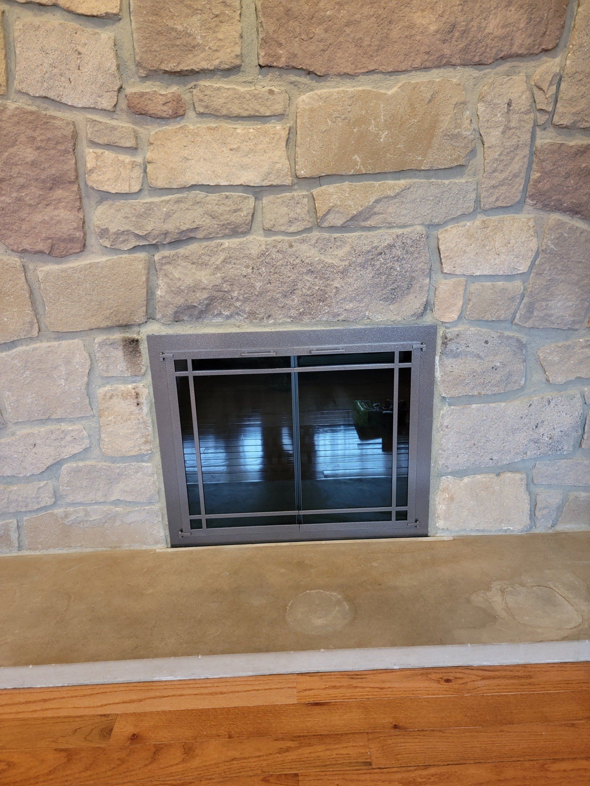 A stone fireplace with a stained glass window