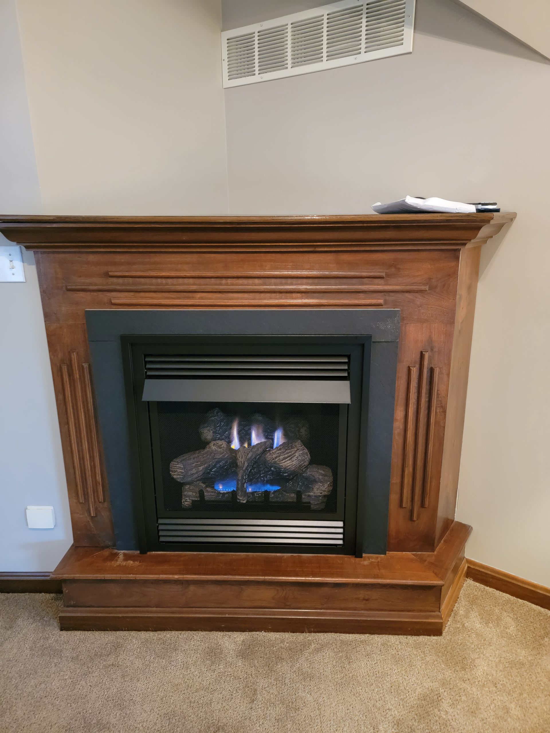 There is a fireplace in the corner of the room.