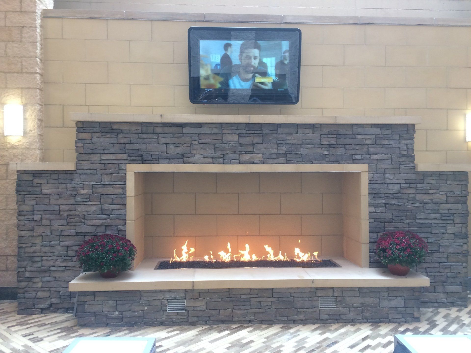 A fireplace with a flat screen tv above it
