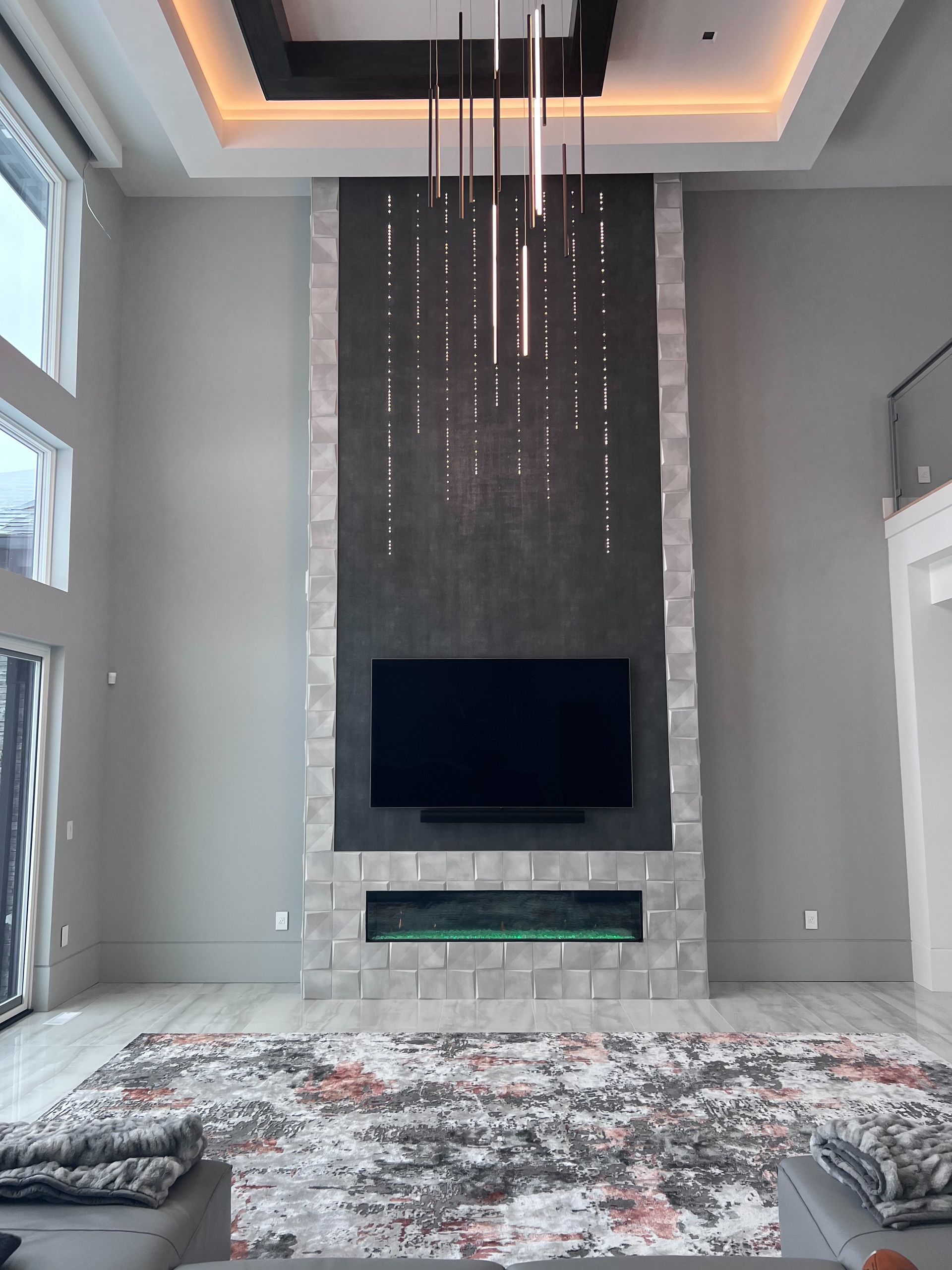 A living room with a fireplace and a flat screen tv