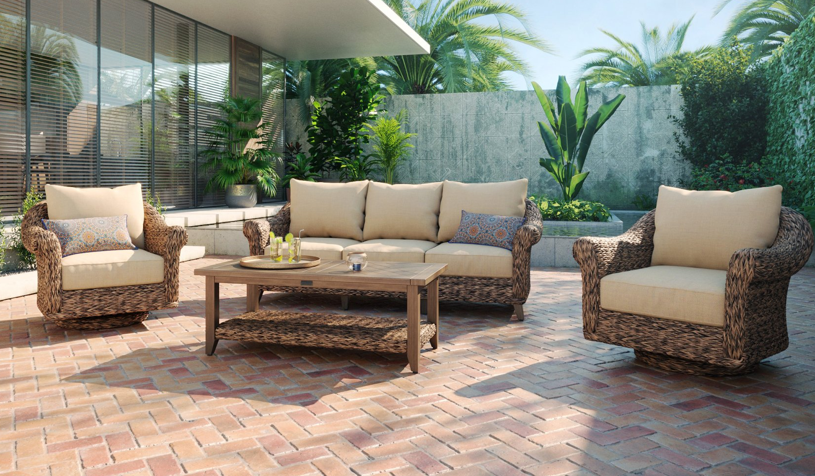 A patio with a couch , two chairs , and a coffee table.