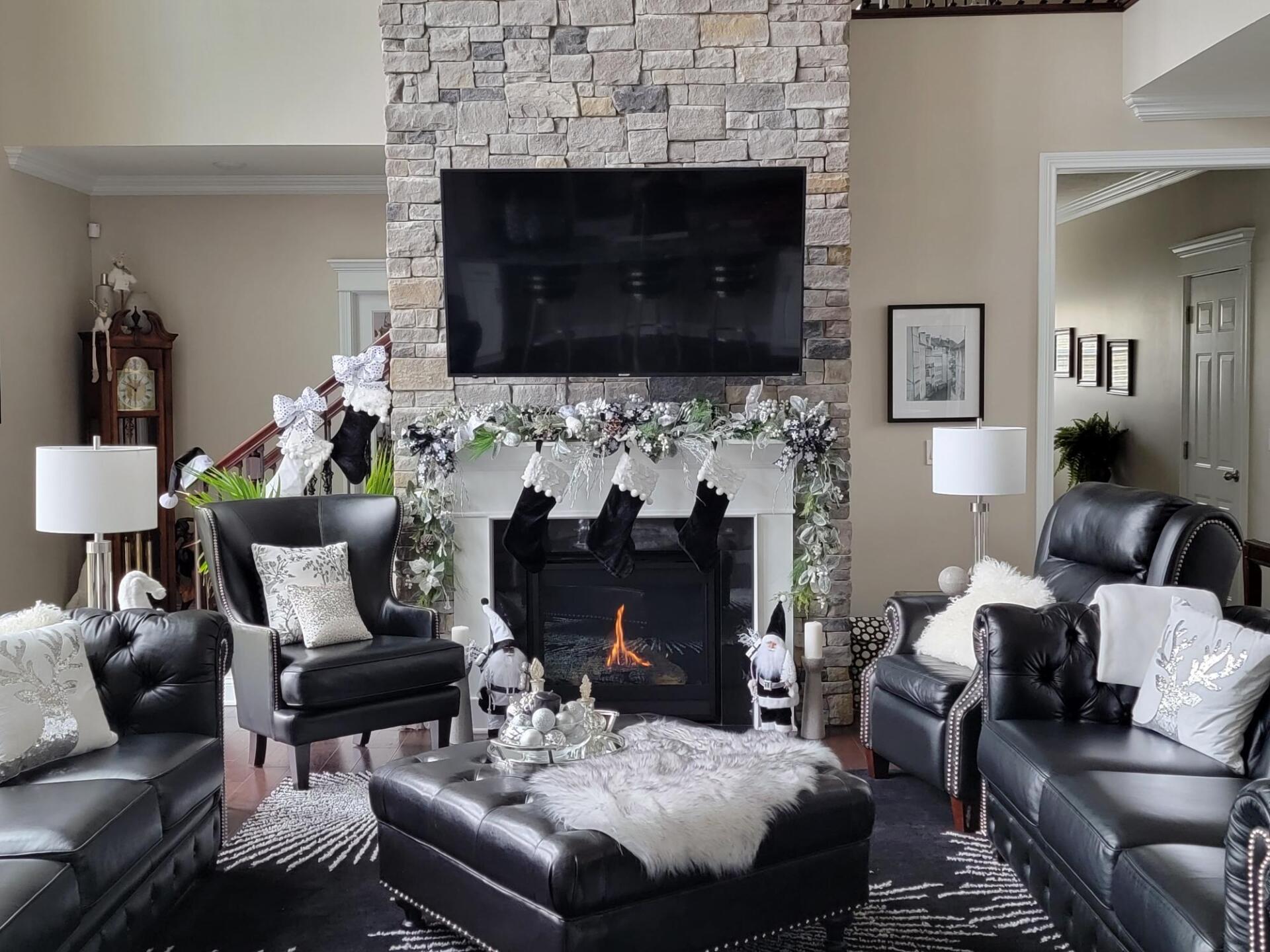 A living room with a fireplace and a flat screen tv.