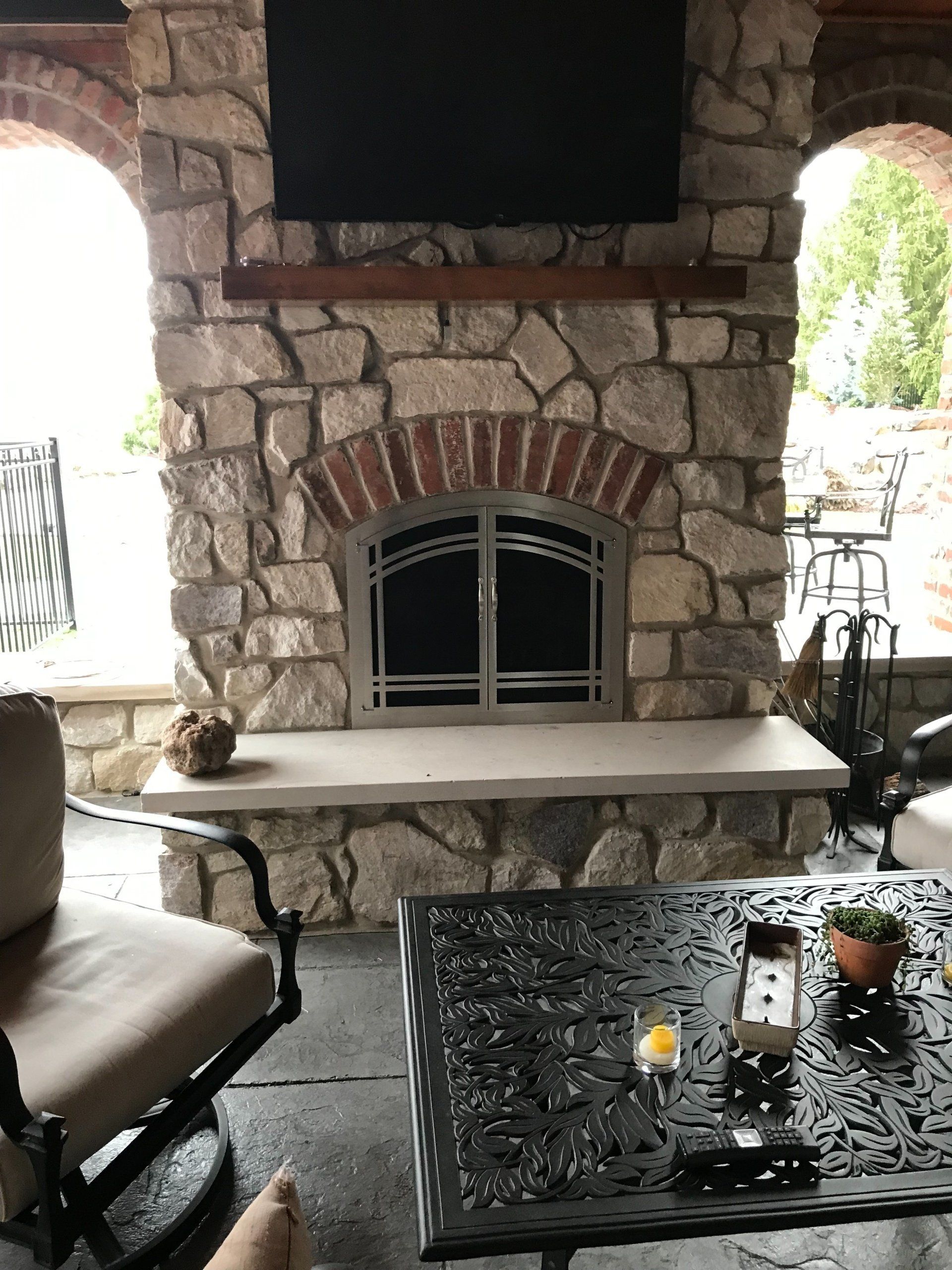 A stone fireplace with a flat screen tv above it