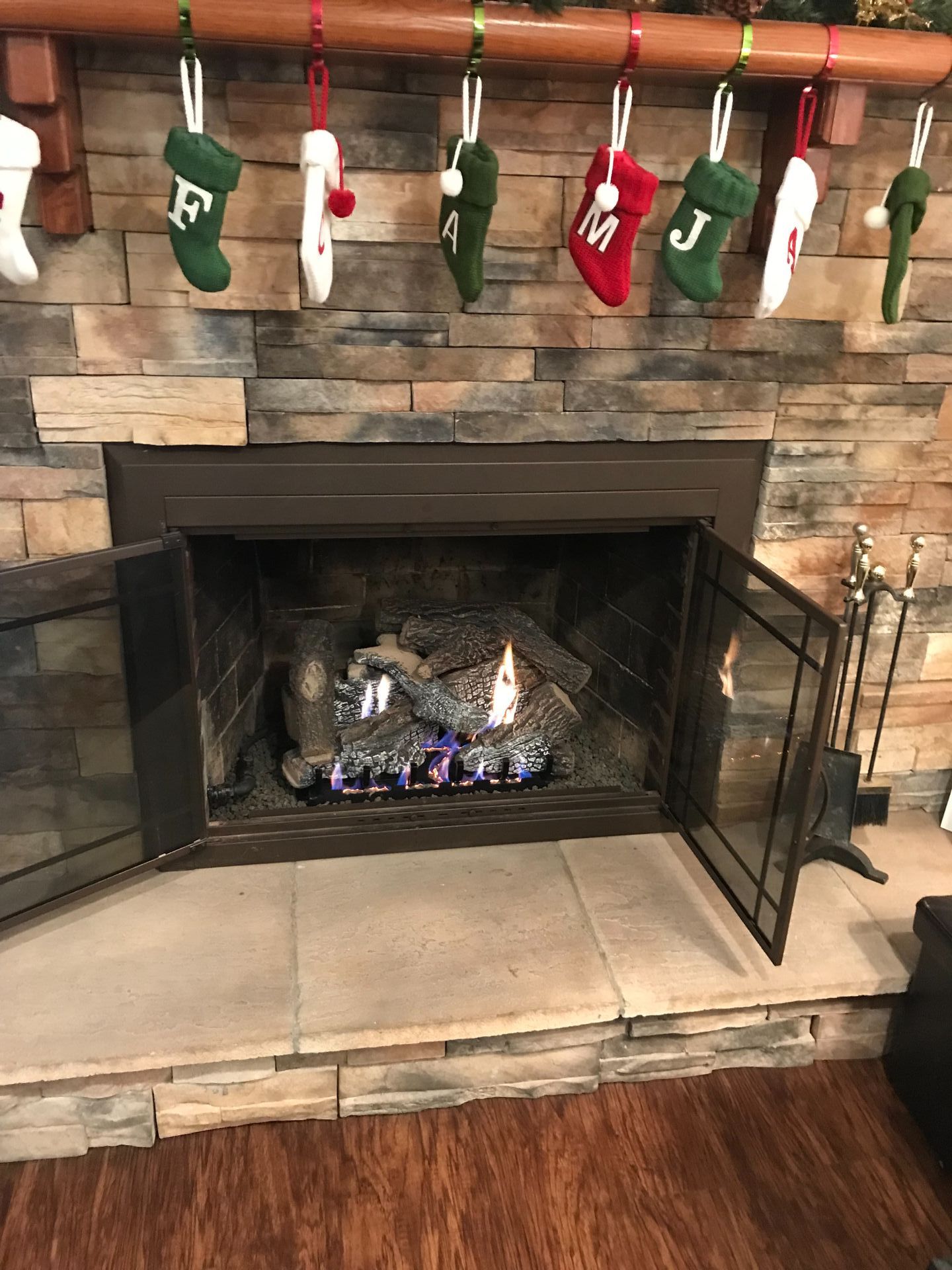 A fireplace with christmas stockings hanging on the mantle.