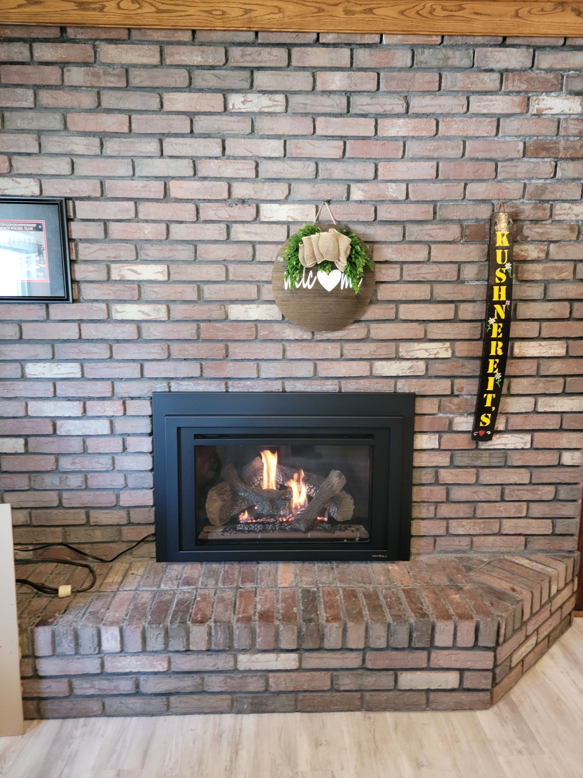 A fireplace in a living room with a brick wall