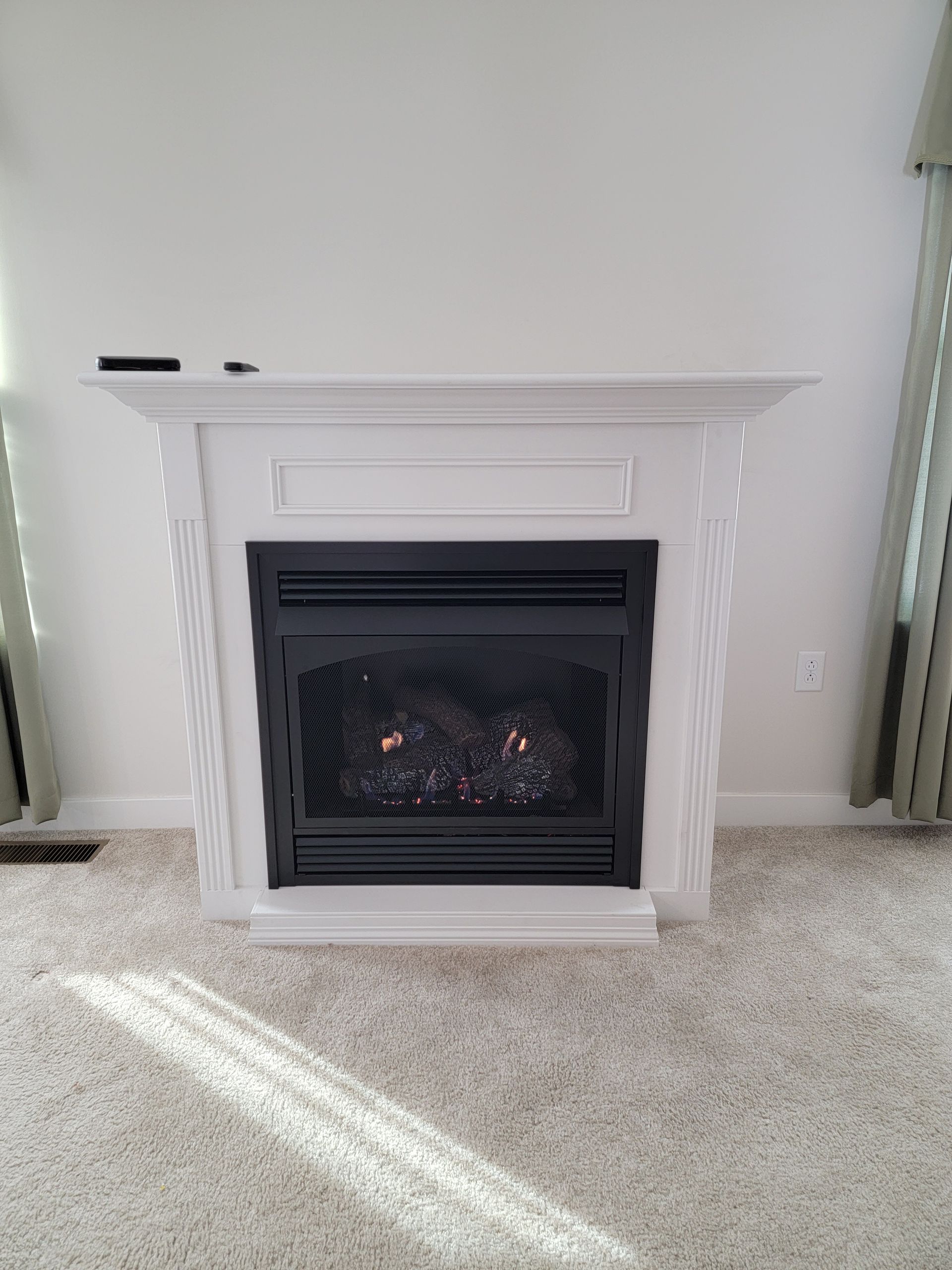 There is a fireplace in the middle of the room.