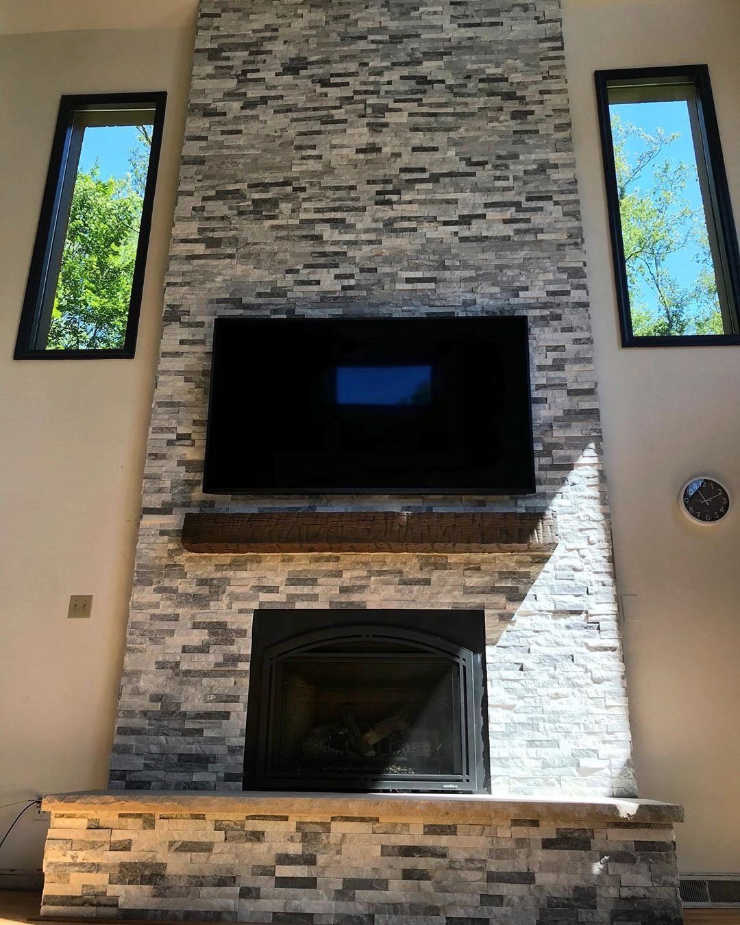 A brick fireplace with a flat screen tv above it
