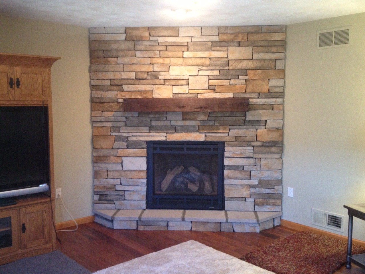 A living room with a fireplace and a flat screen tv