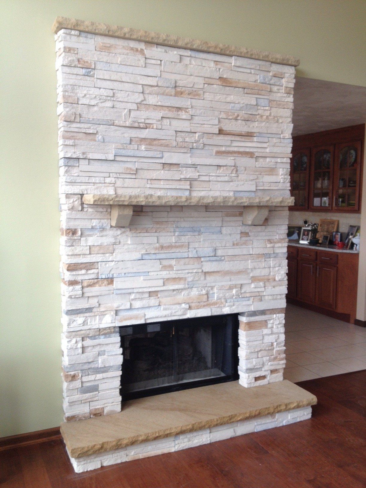 A fireplace in a living room with a brick wall