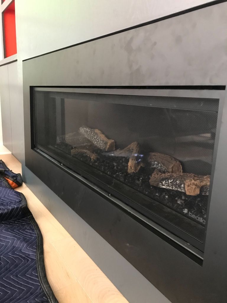 A fireplace with a lot of logs in it