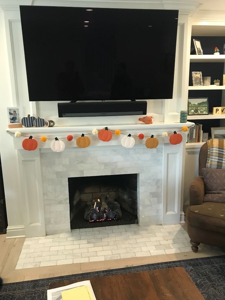 A living room with a fireplace and a flat screen tv.