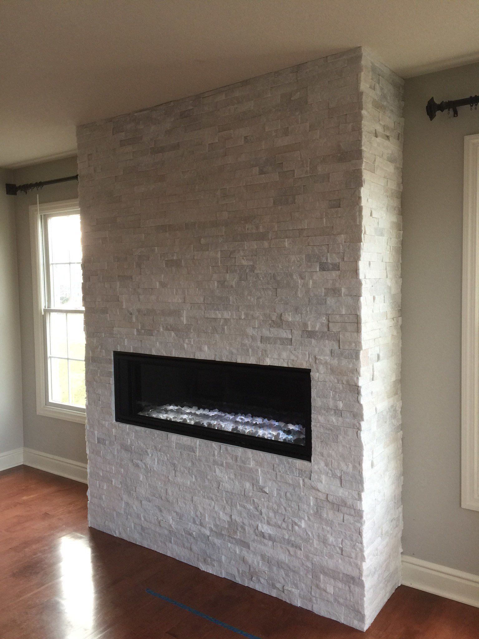 There is a fireplace in the middle of the room.