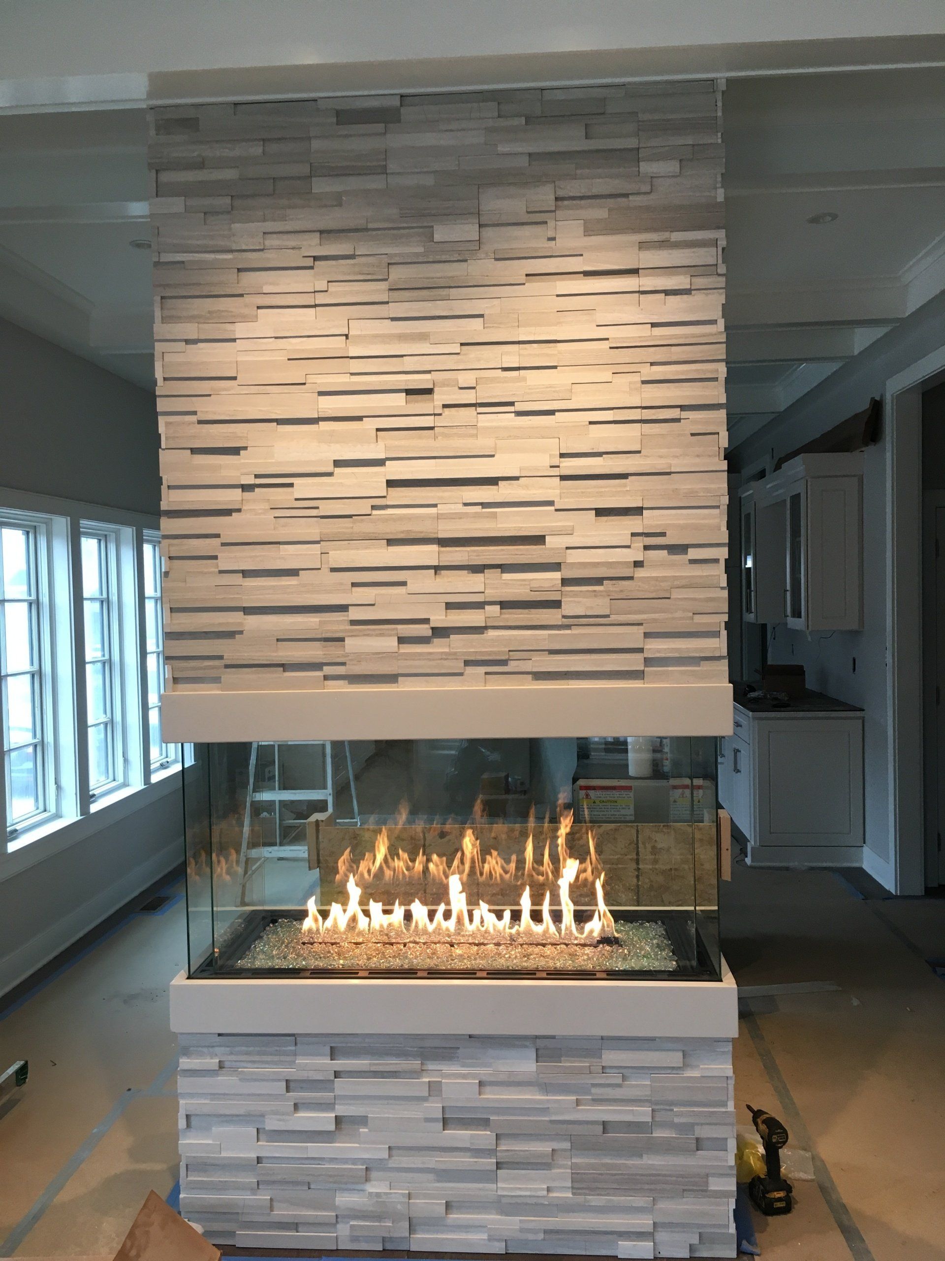 A fireplace in a room with a brick wall