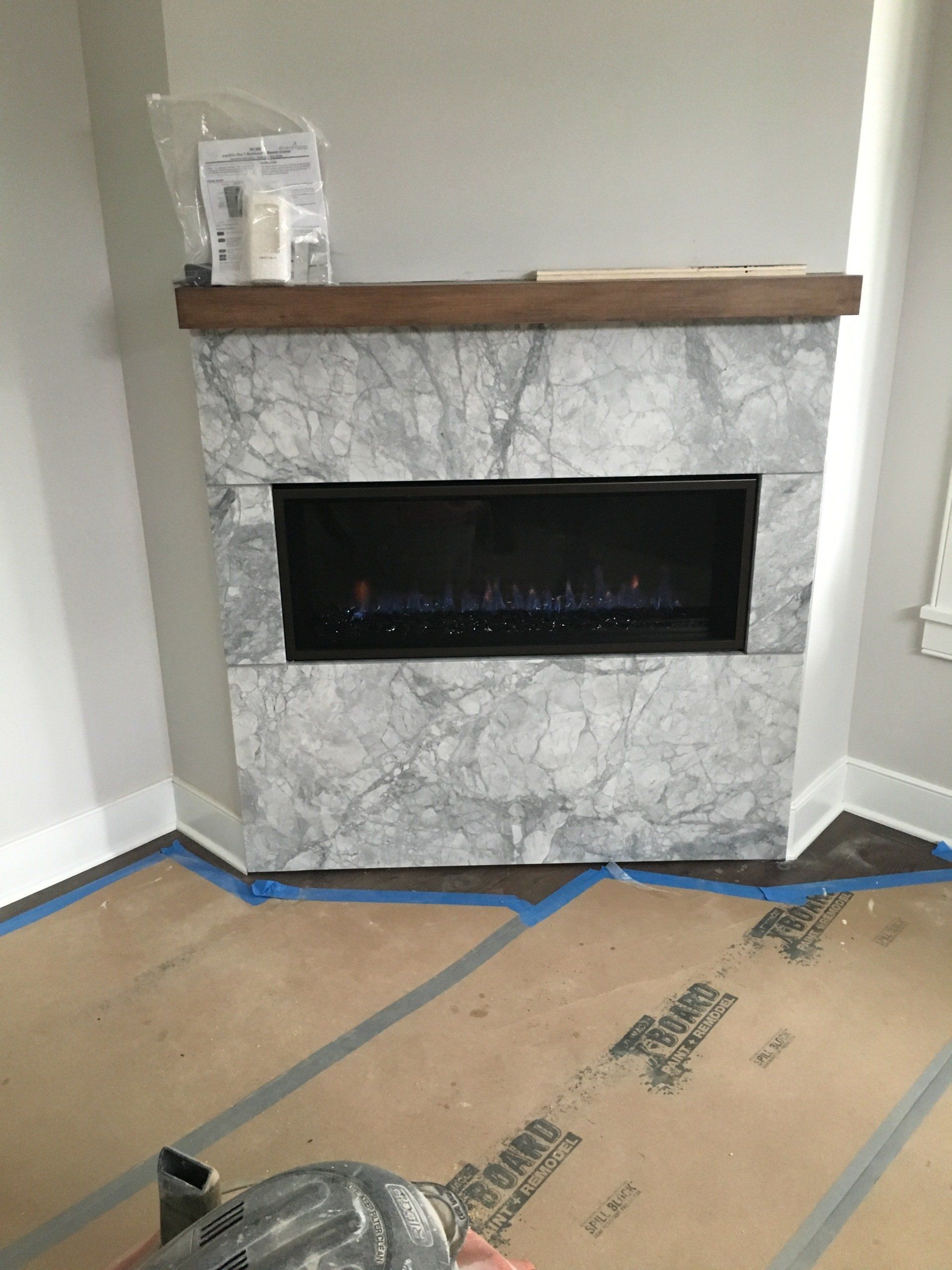 There is a fireplace in the corner of the room.