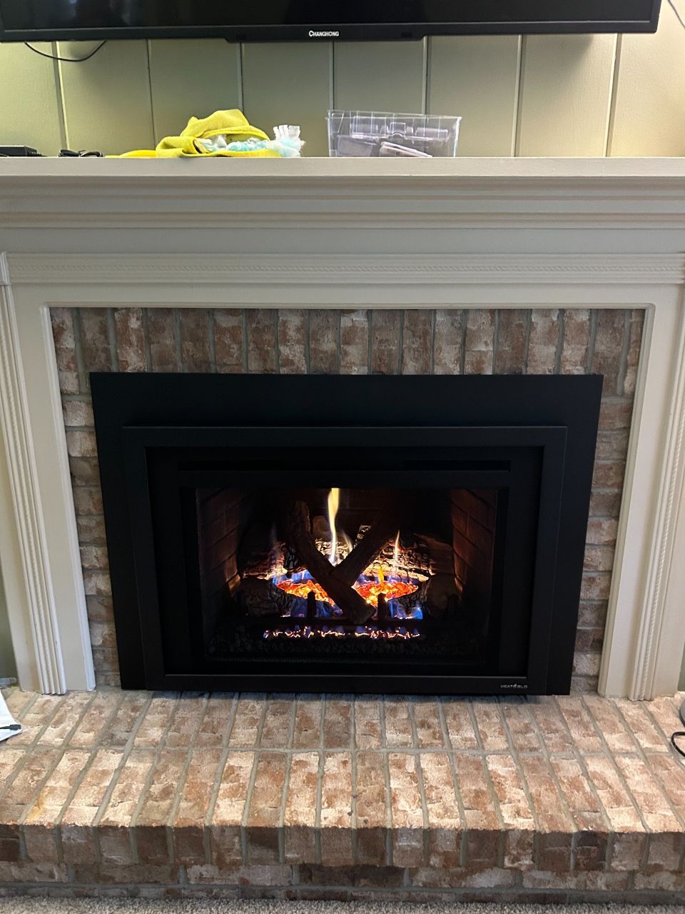 A fireplace with a tv above it in a living room.