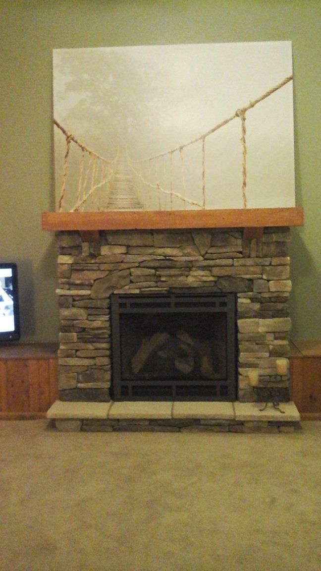 A living room with a fireplace and a television.