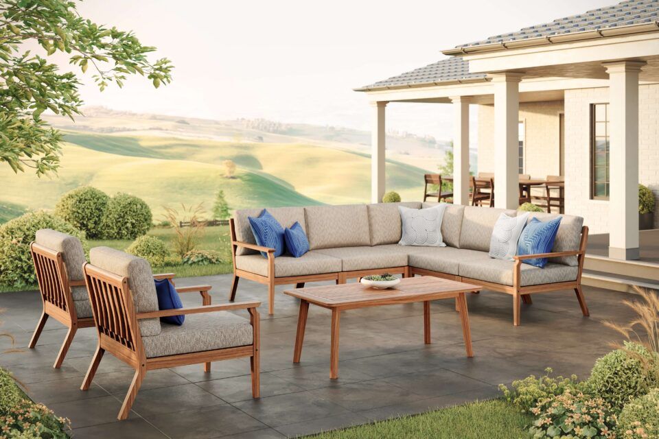 A wooden patio set with a table and benches in front of a stone fireplace.
