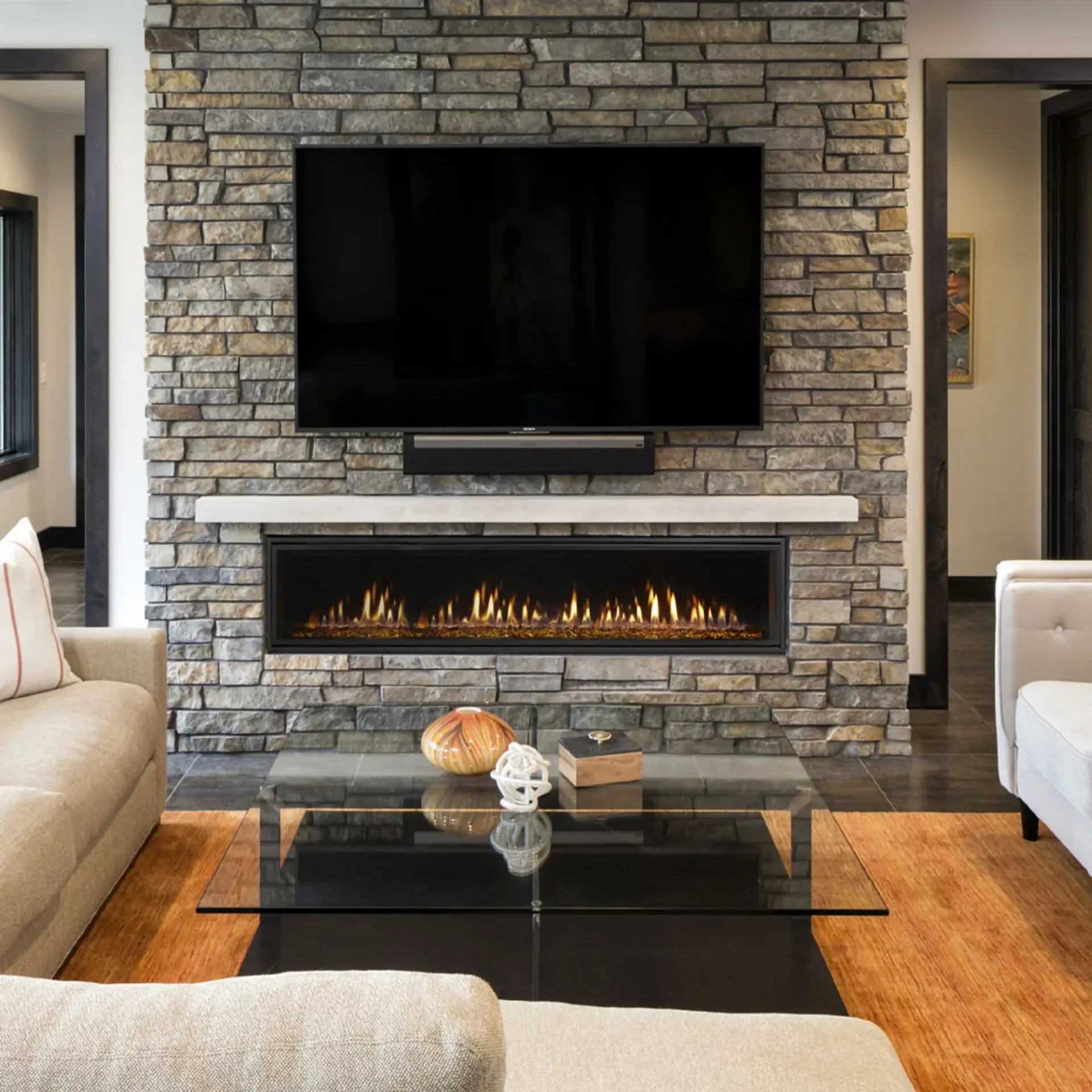 A living room with a fireplace and a painting on the wall above it