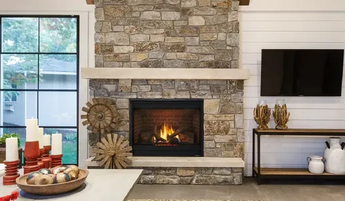 A living room with a fireplace and a flat screen tv.