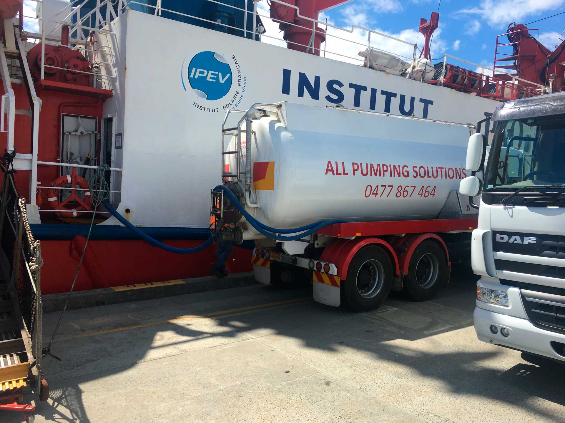 Tanker truck refueling a ship,