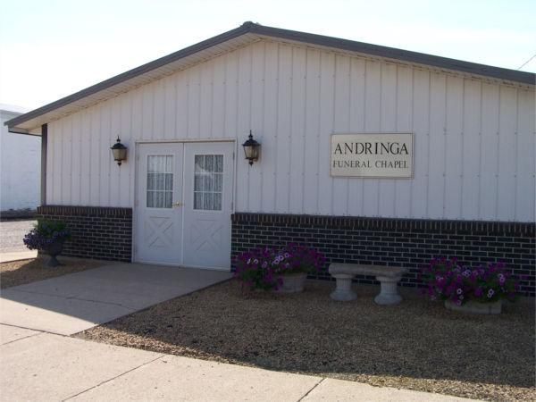a white building with a sign that says andringa funeral chapel