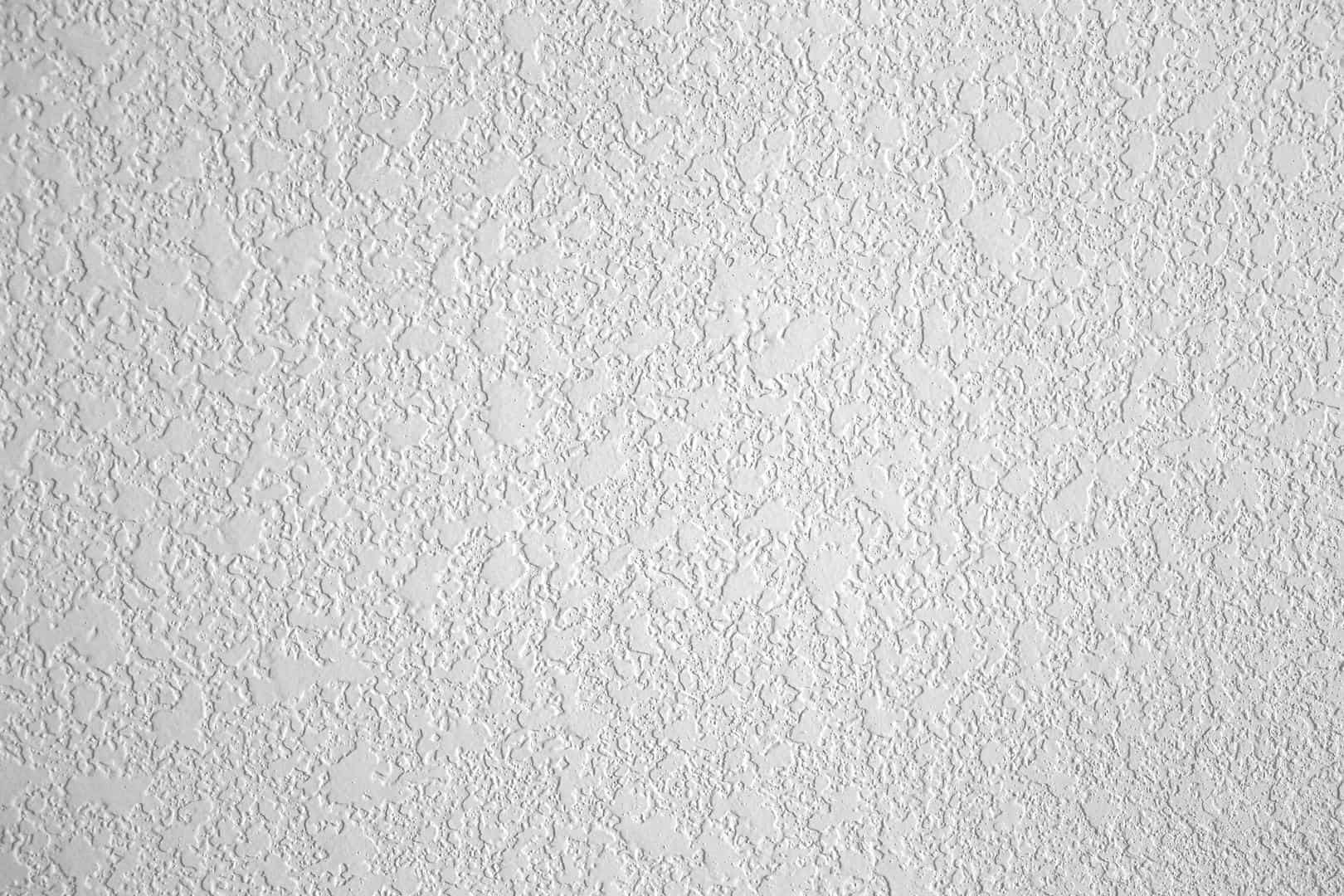 A close up of a white wall with a texture.
