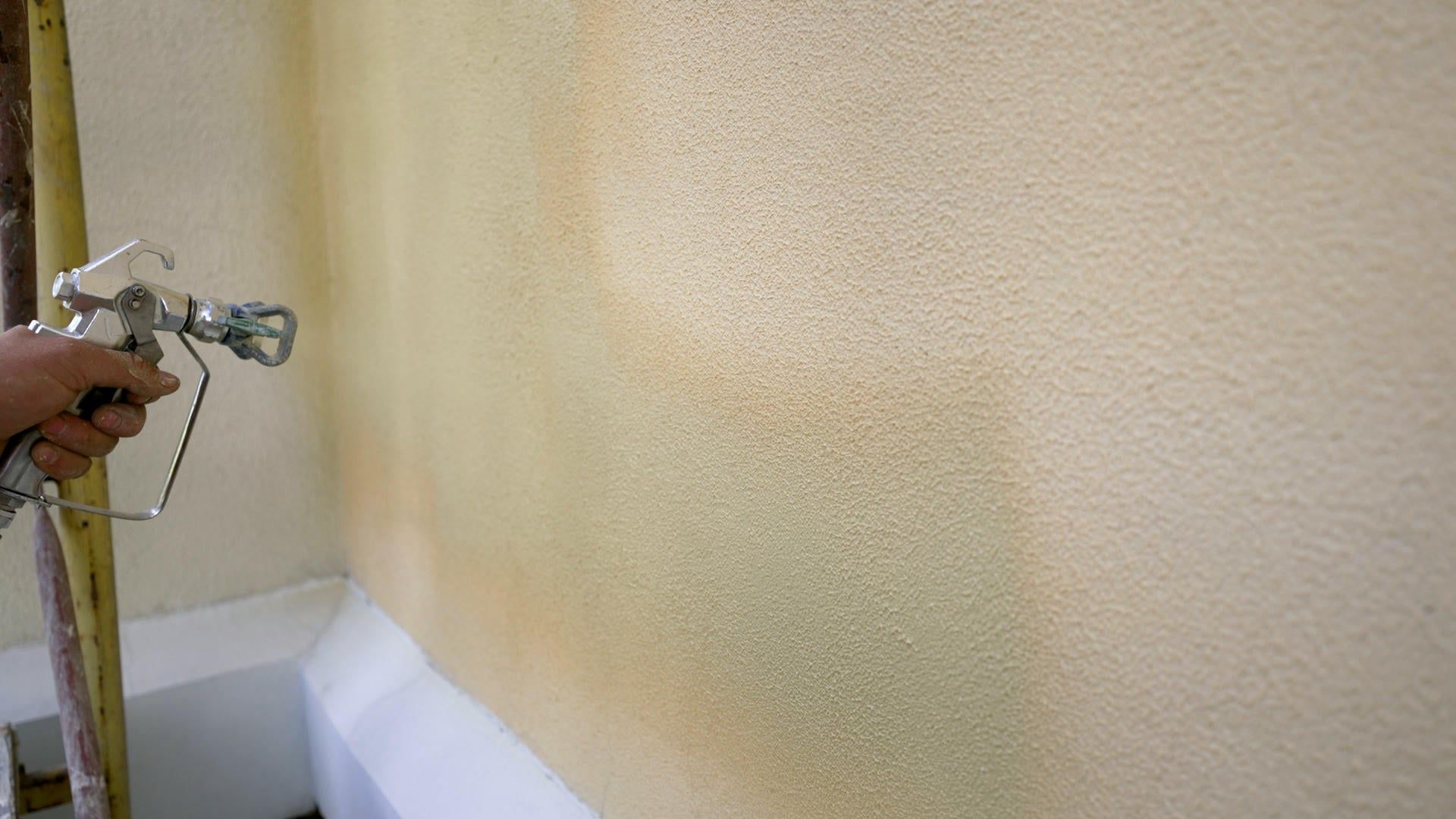 A person is spraying paint on a wall.