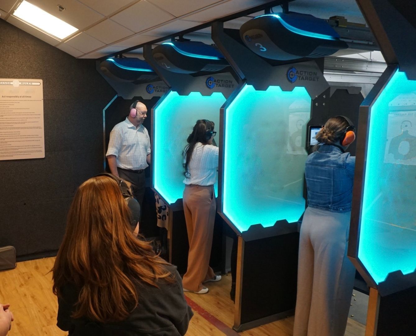 Instructor guiding woman during Firearm-Informed Therapy handgun safety training outdoors