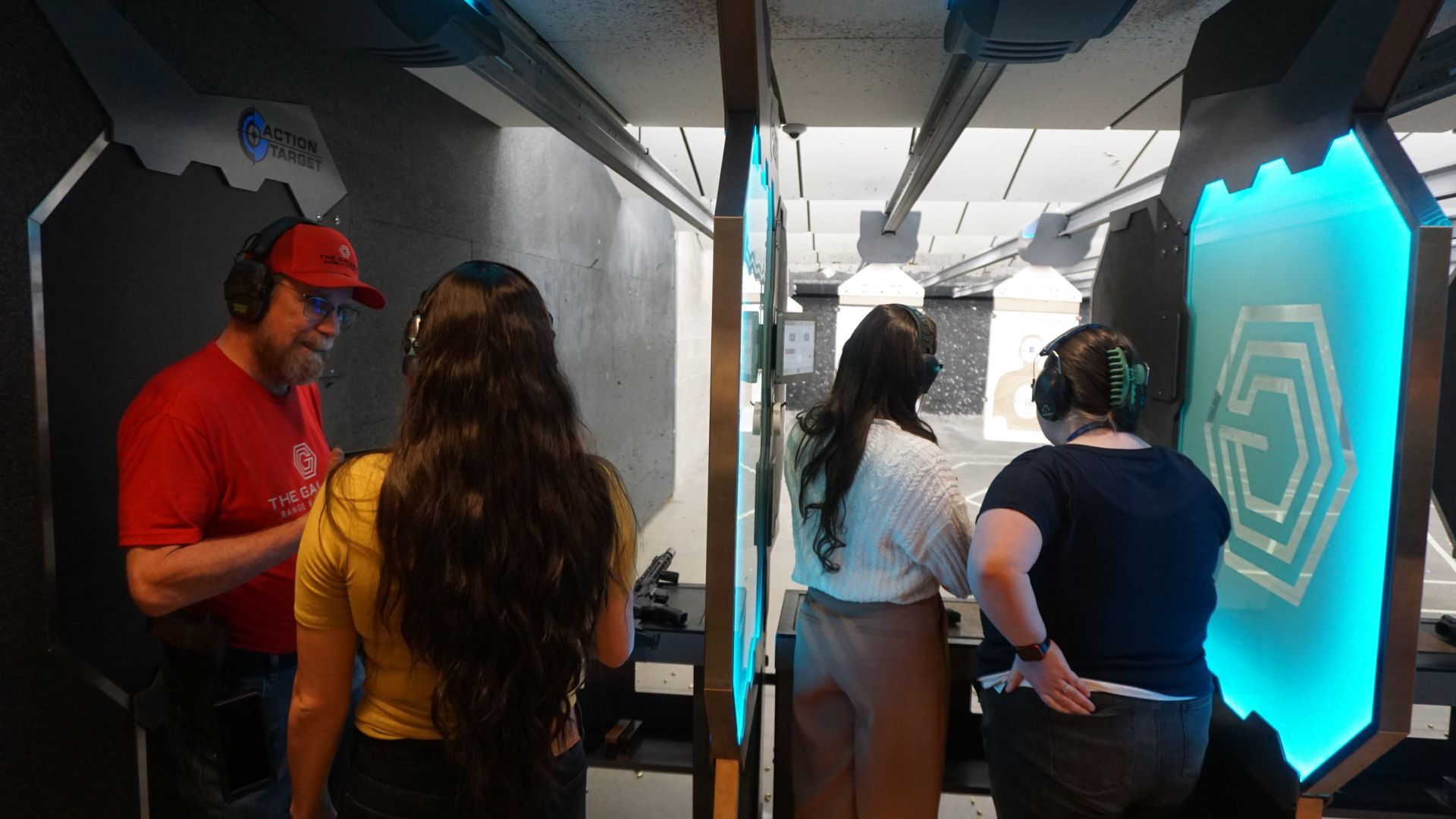 Participants receiving firearm training at indoor range with Mind Safety Institute