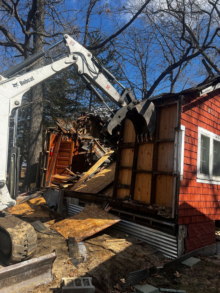 Bulldozer Demolishing a House — Prairieburg, IA — L & R Dumpsters