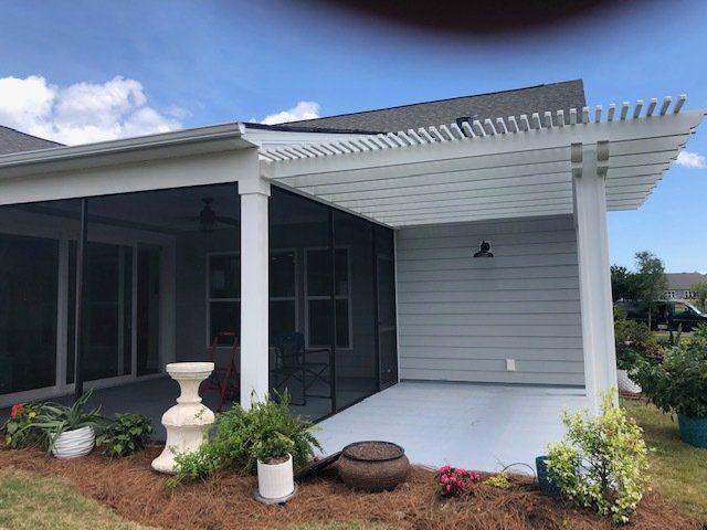 Pergola installation outside of a sunroom in Wilmington, NC