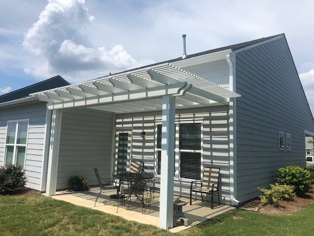 Seating area under outdoor pergola in Wilmington, NC