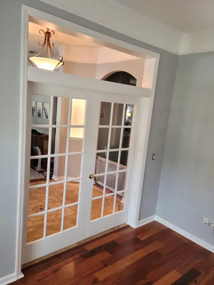 A living room with hardwood floors and french doors