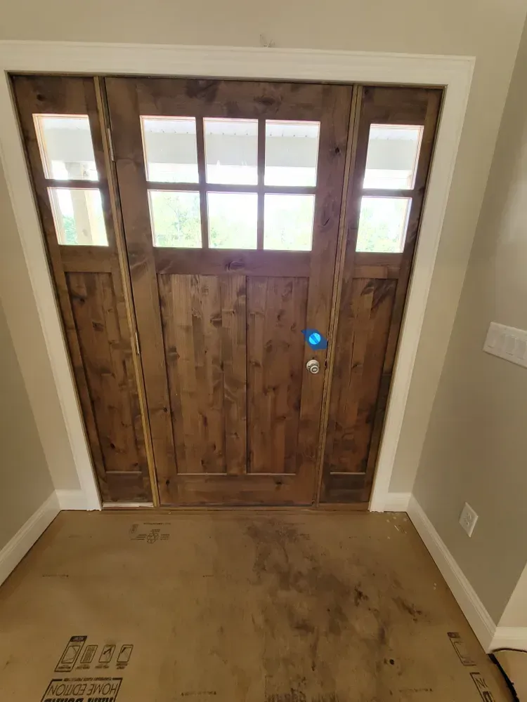 A wooden door with a lot of windows in a room.