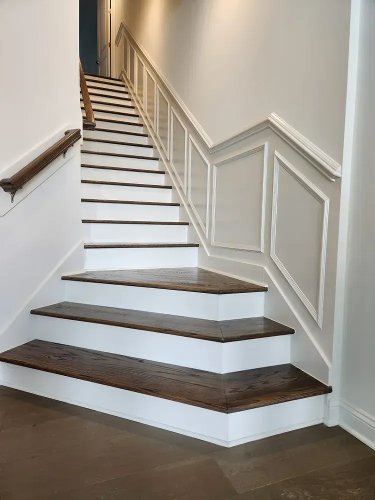 A set of stairs with white railings and wooden steps